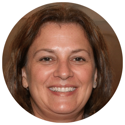 A woman with glasses and shoulder-length hair, smiling.