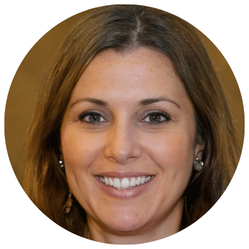 Smiling woman with short, dark hair and earrings in a circular photo.