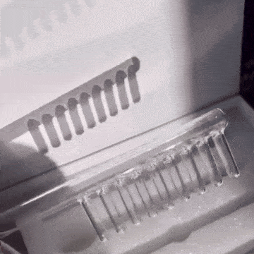 A comb casting a shadow on a white surface.