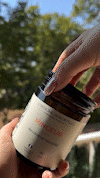 Hand opening a jar labeled 'Minceur' with trees in the background.