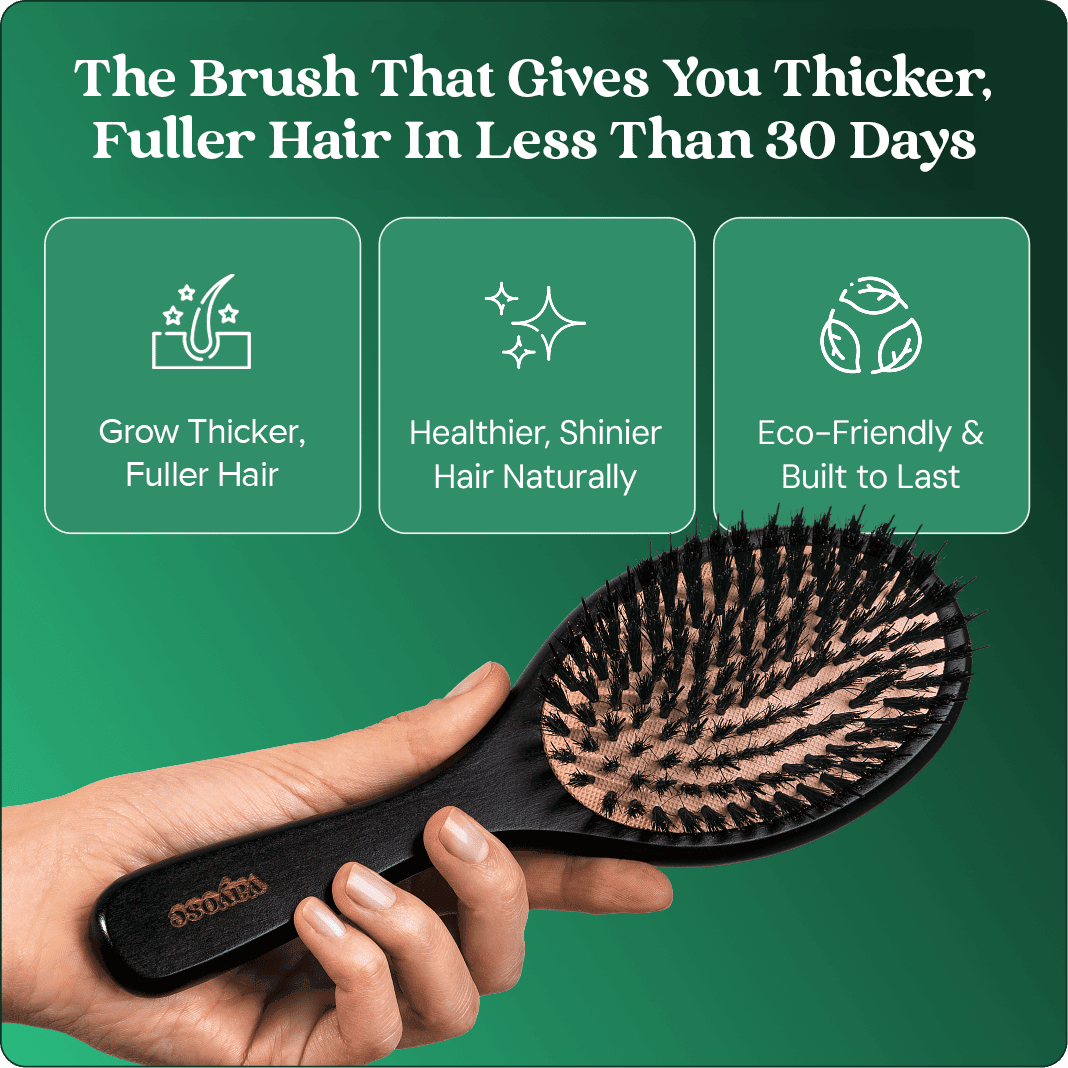 Hand holding a black hairbrush with text about hair benefits.