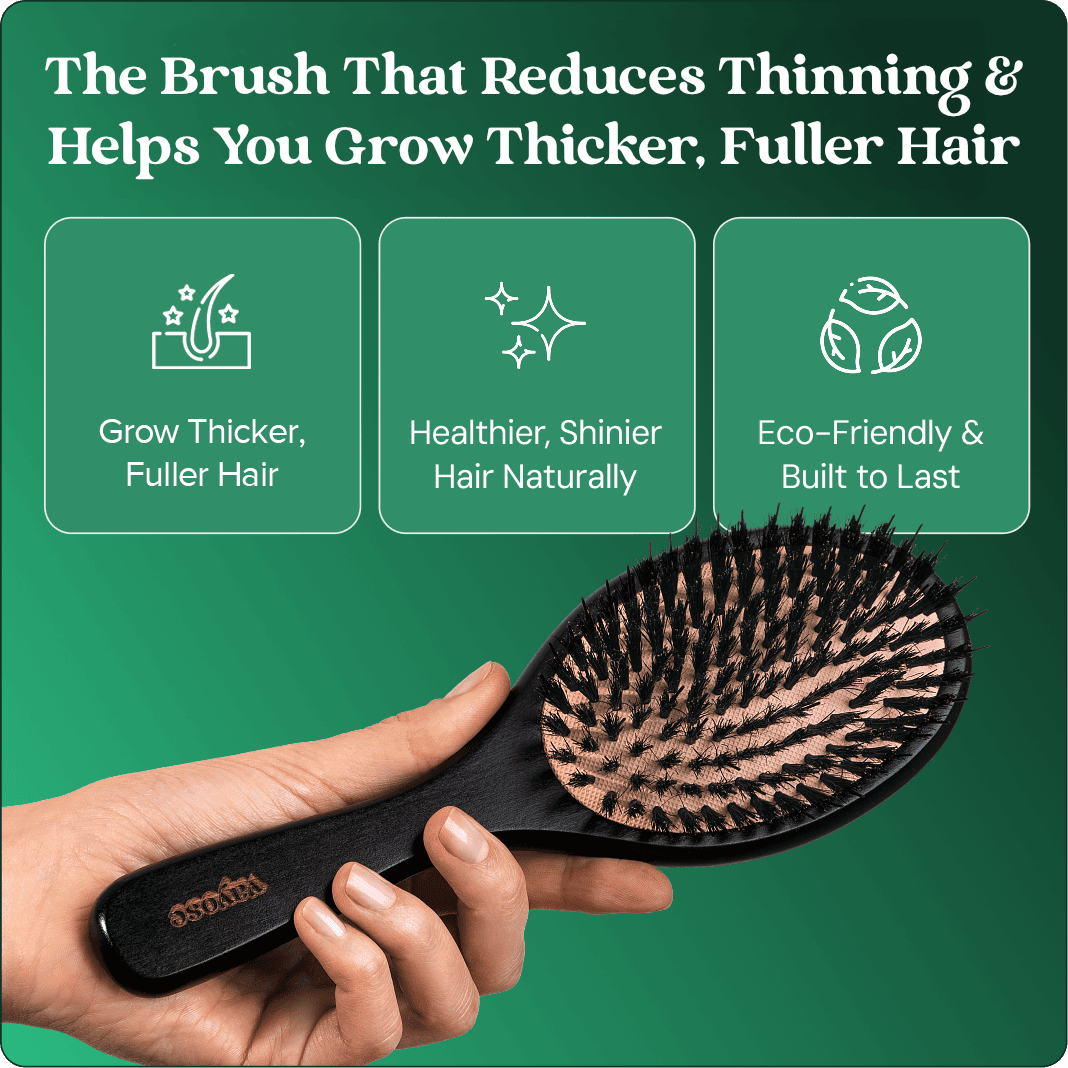 A hand holding a black bristle hairbrush with text listing benefits for growing thicker, fuller hair.