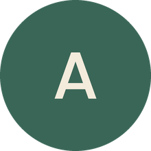 An off-white capital letter A centered inside a dark green circle.