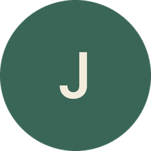 The capital letter J inside a dark green circle.
