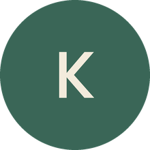 A cream-colored capital letter K inside a dark green circle, likely a placeholder image.