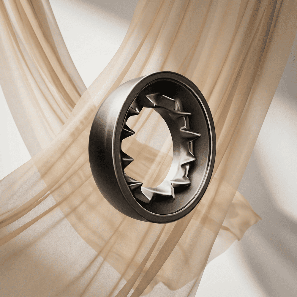 A dark metal ring with an inner spiked design floating in front of a sheer beige curtain.