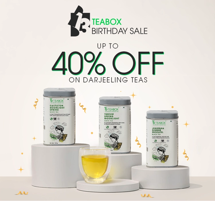 An advertisement for Teabox's birthday sale, featuring three tins of Darjeeling tea and a glass of tea.