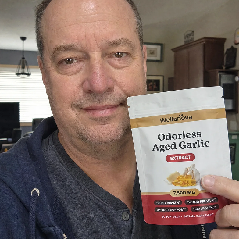 A man holds up a pouch of Wellanova Odorless Aged Garlic extract supplement.