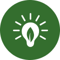 A green circular icon showing a white lightbulb with a leaf inside and rays of light shining from it.