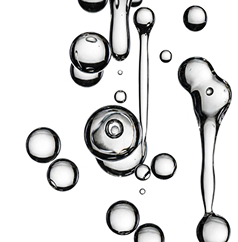 A close-up of clear liquid bubbles and drips against a white background.