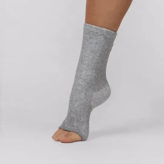 Gray sock with open toes on a person's foot.