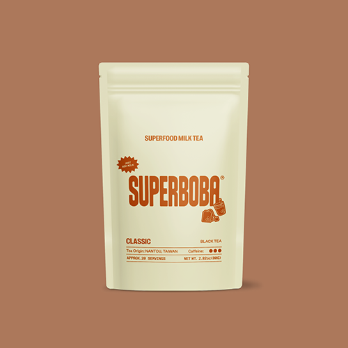 Package of Super Boba superfood milk tea on a brown background.