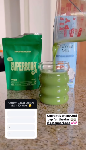 Green drink being poured into a glass, with Super Boba and coconut milk packages nearby.