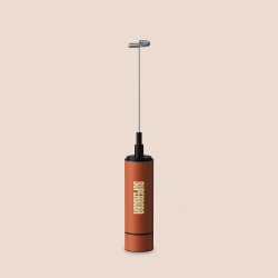 Red handheld frother with a silver whisk against a beige background.