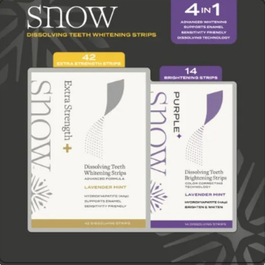Two boxes of Snow dissolving teeth whitening strips on a dark background.