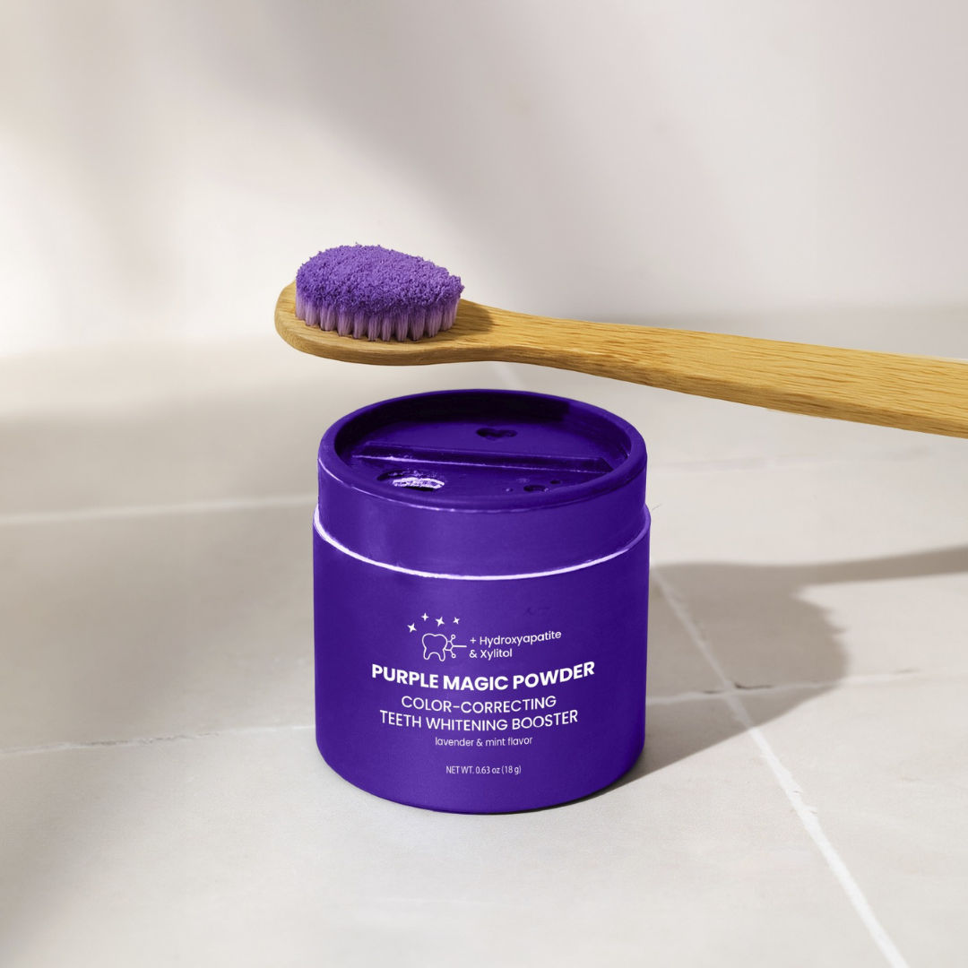 Purple powder on toothbrush next to a purple container labeled 'Purple Magic Powder.'