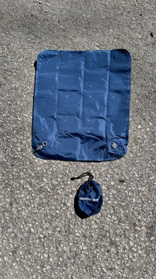 Blue mat and pouch on a textured surface.
