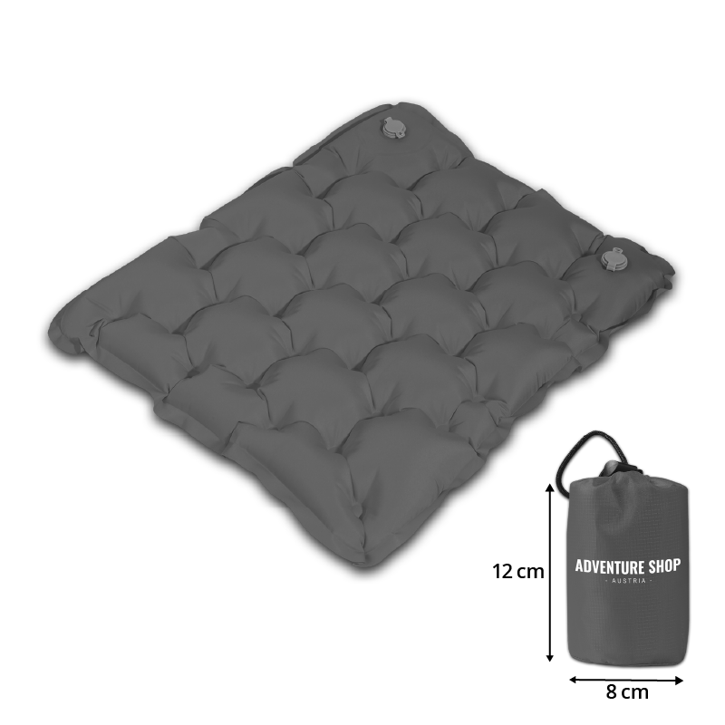 Inflatable camping mat with a compact carry bag, labeled 'Adventure Shop Austria.'