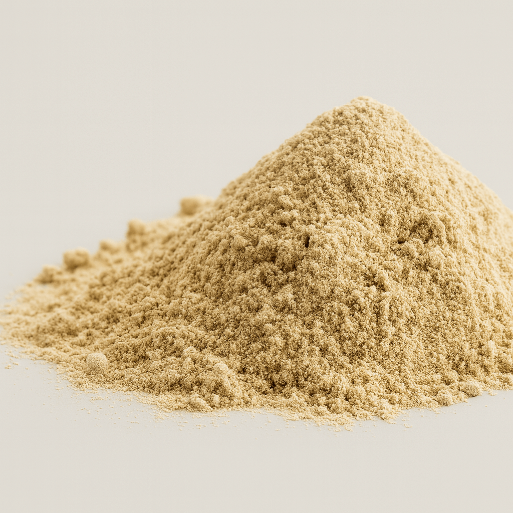 A pile of light brown powder on a plain background.