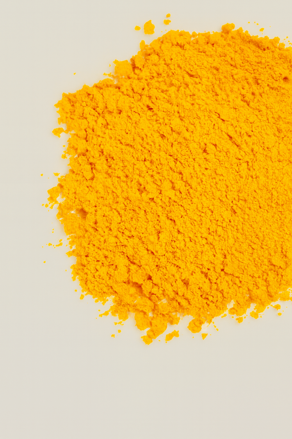Bright yellow powder spread on a light surface.