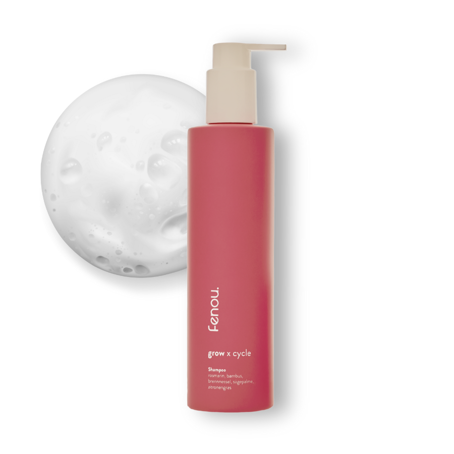 Red shampoo bottle with pump, next to a white foamy texture.