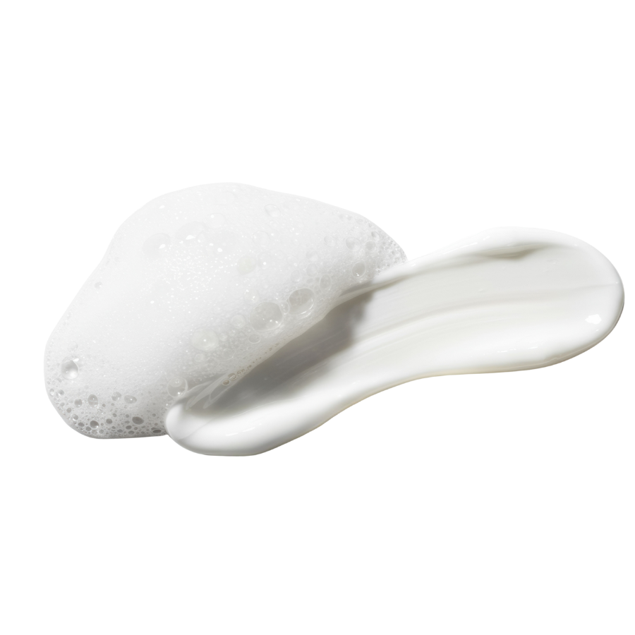 White cream with foam bubbles on a white background.