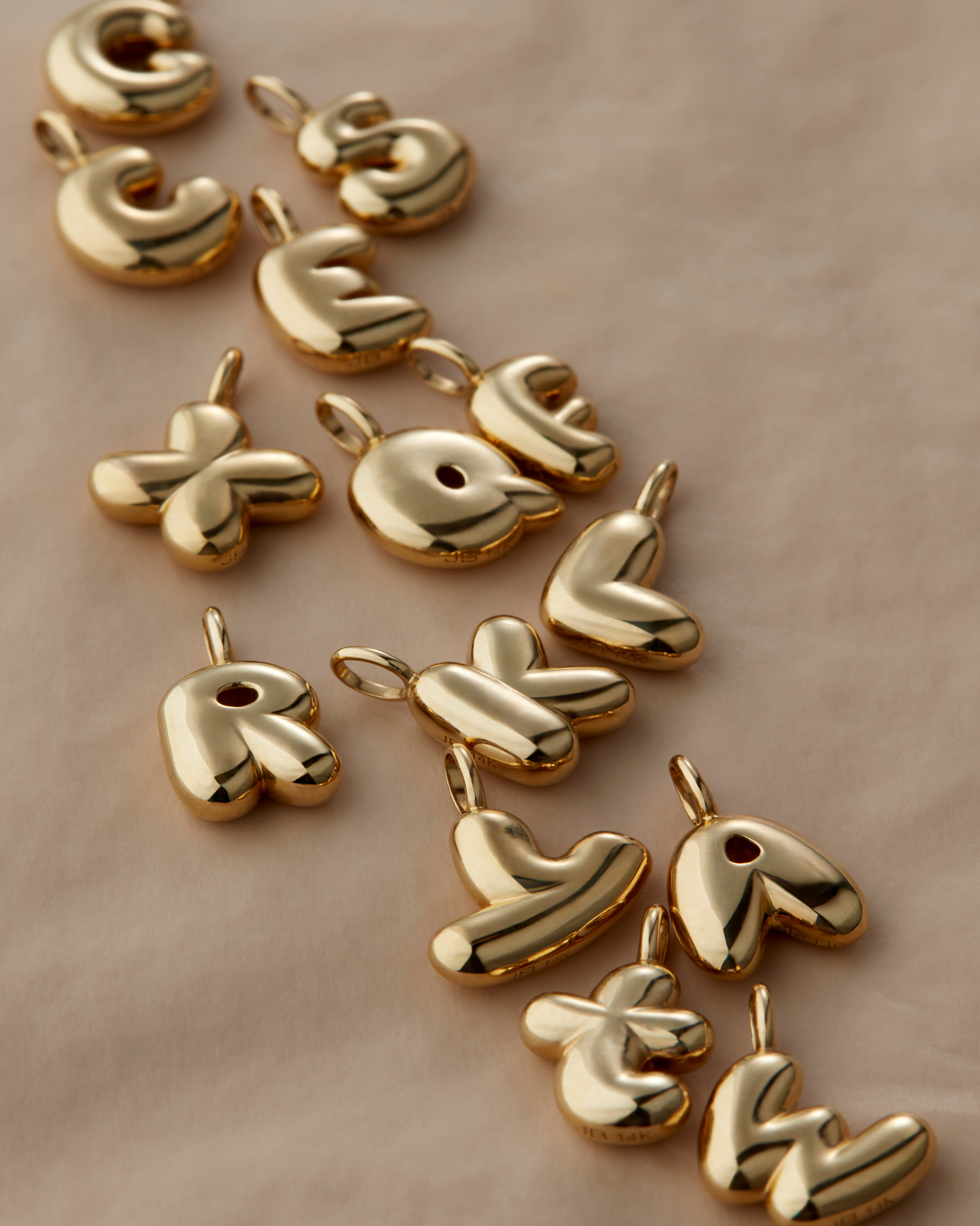 Three interlocking silver rings on a beige background.