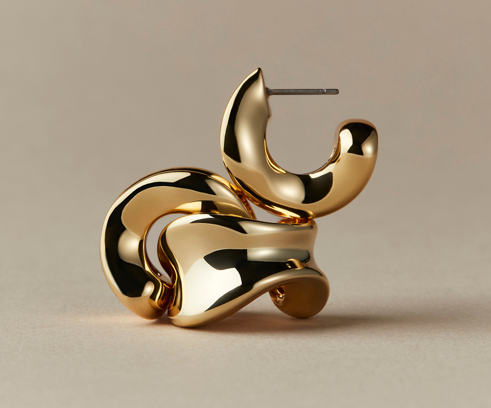 Abstract gold sculpture with smooth, curved surfaces on a neutral background.