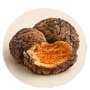 Two dark, round cookies, one broken in half to show a golden-brown, textured filling.