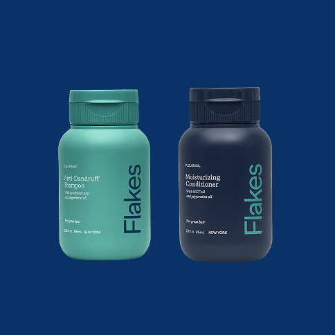 Two bottles of Flakes hair products on a blue background.