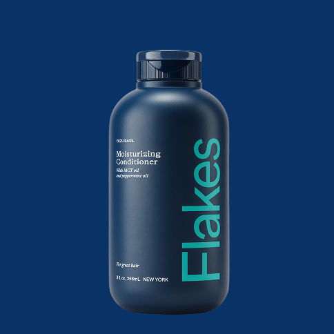 Dark blue bottle of moisturizing conditioner labeled 'Flakes' on a blue background.
