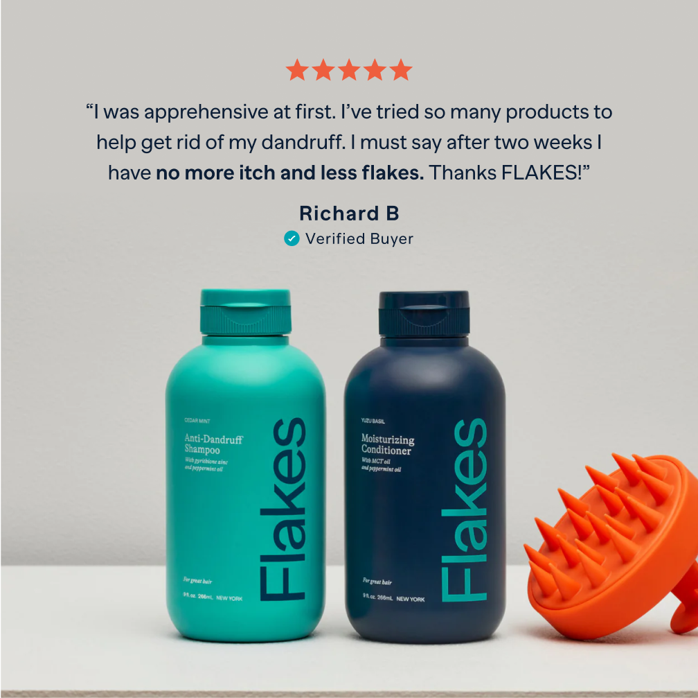 Two bottles of Flakes hair products with a scalp massager and a customer review.