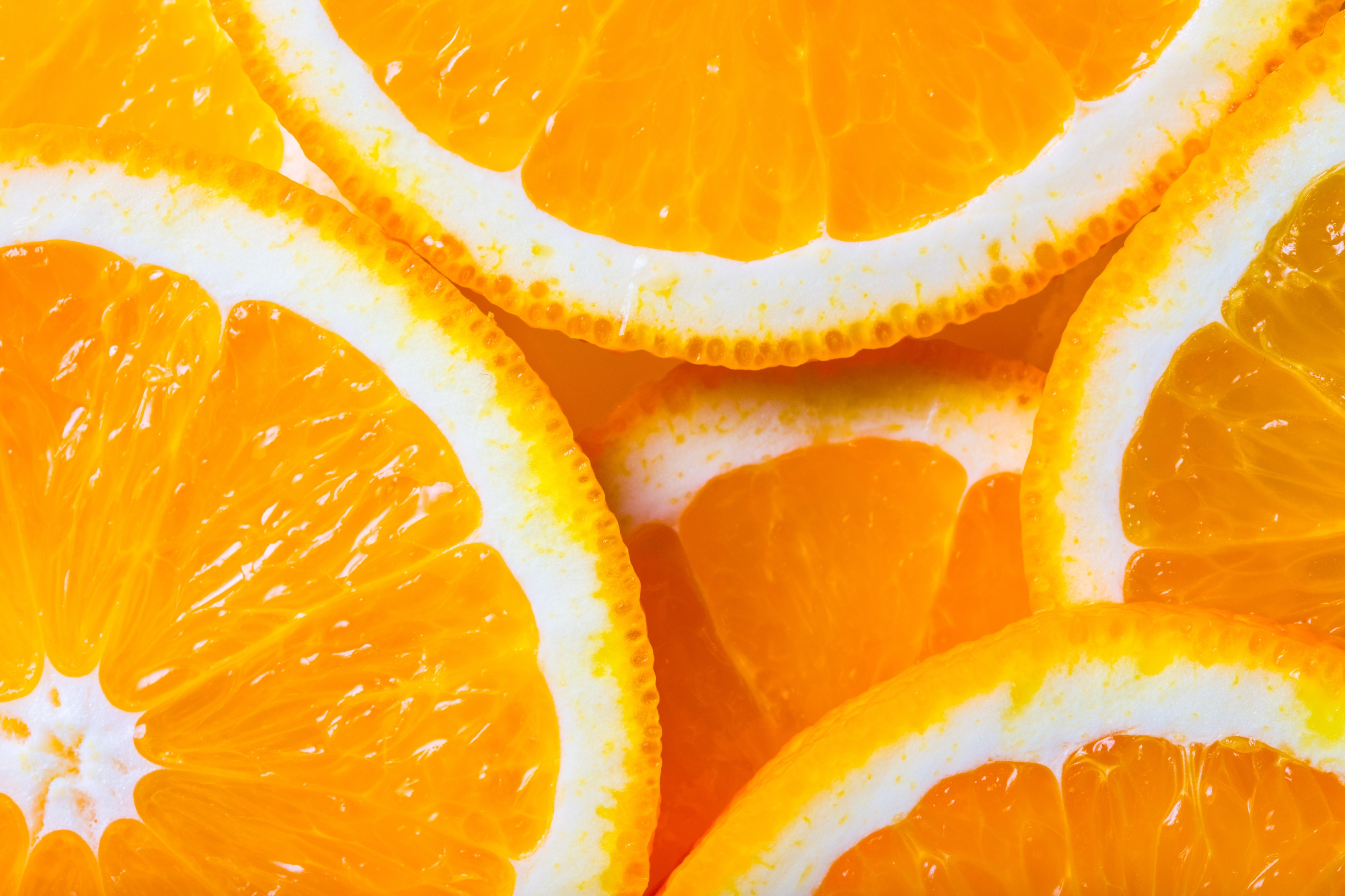 Slices of fresh, juicy oranges with vibrant orange and white colors.