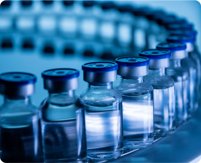 Row of glass vials with blue caps in a laboratory setting.