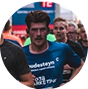 A group of people running in a race, wearing athletic gear.