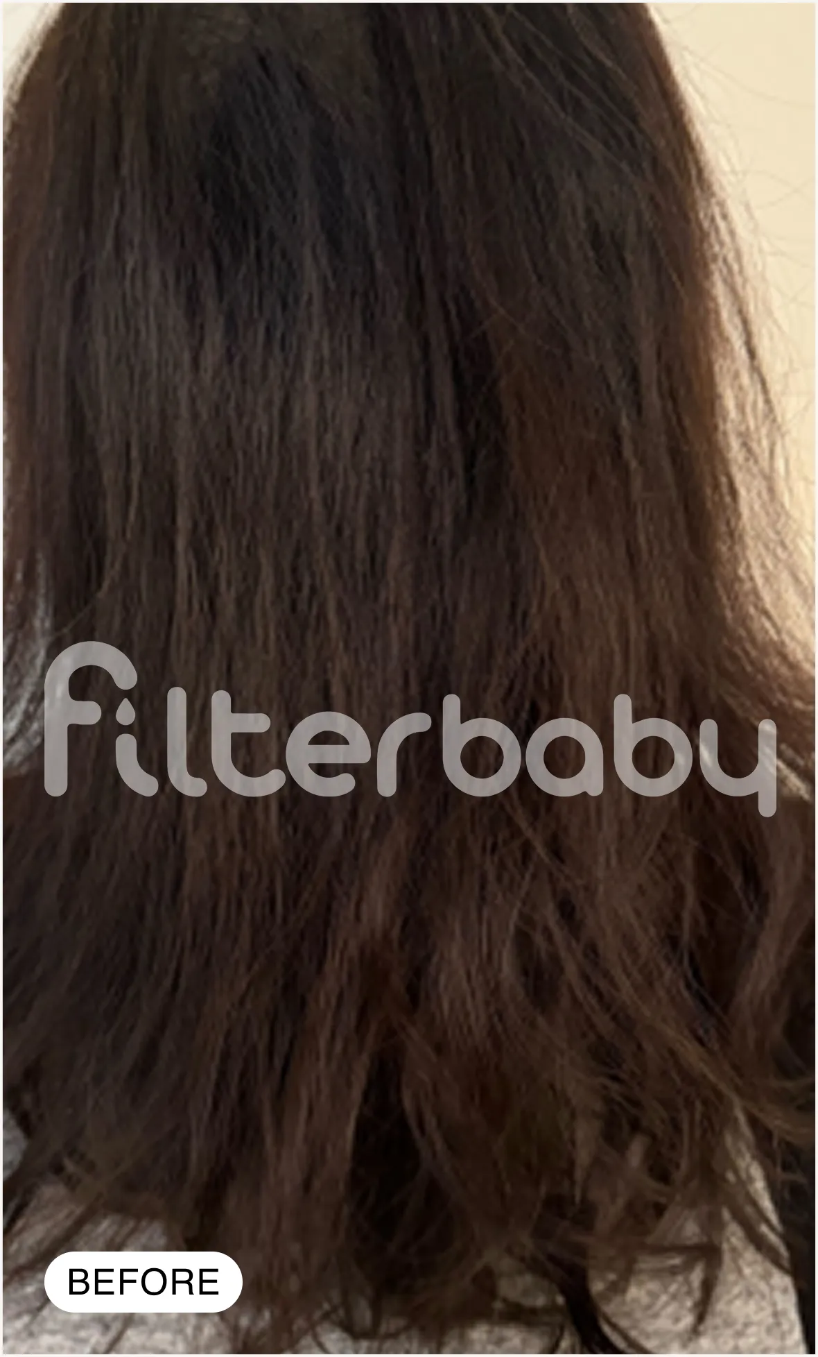 A before photo showing the back of a person with dark brown, slightly frizzy, wavy hair.