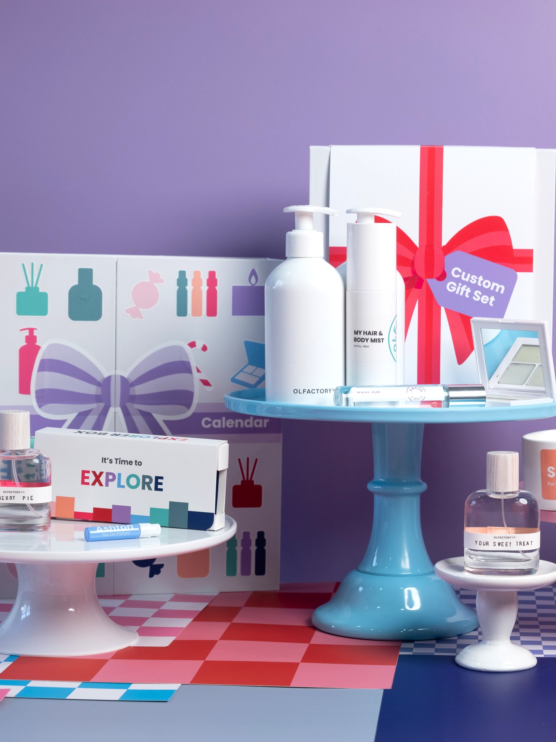 Assorted cosmetic products displayed on colorful cake stands against a purple background.