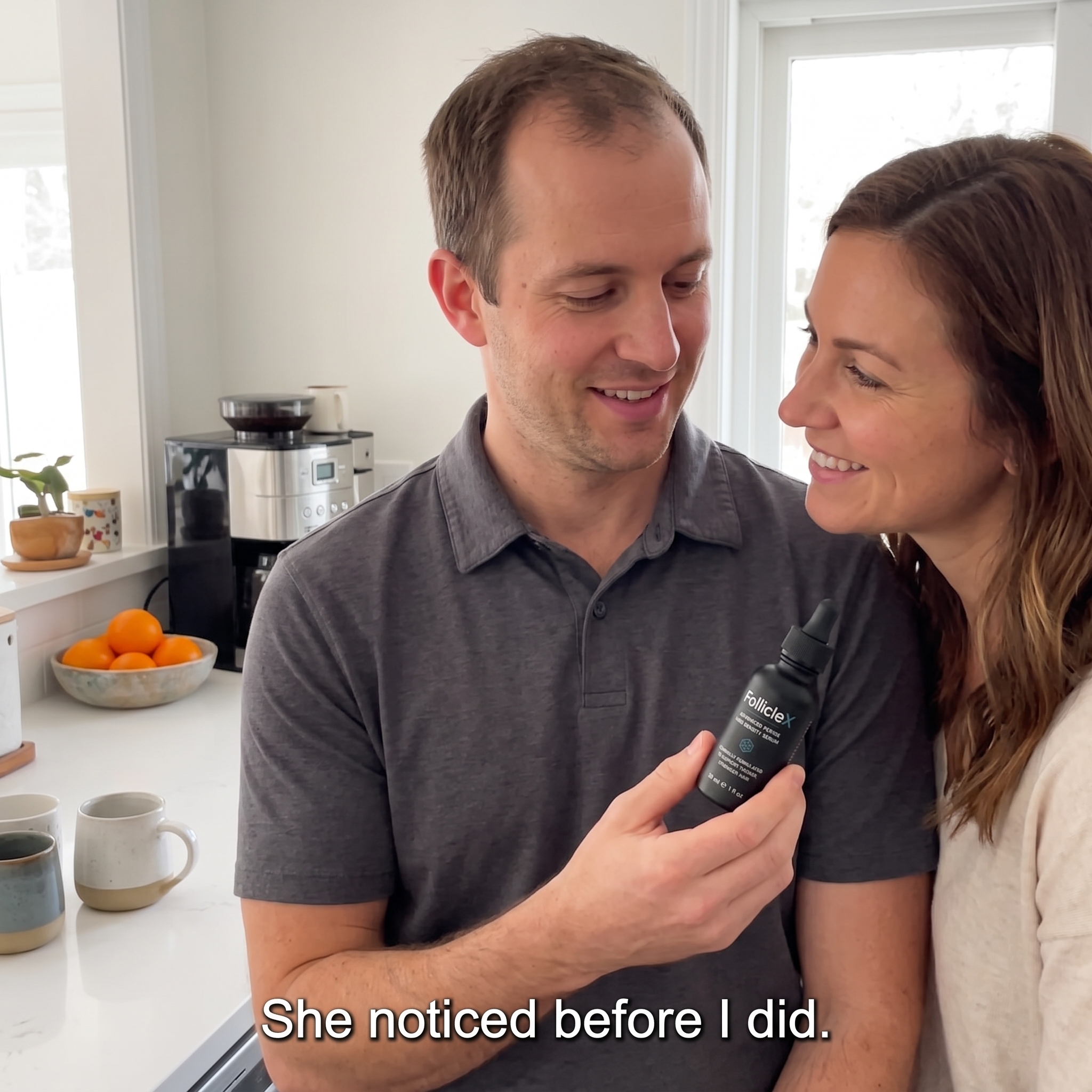 A man holds a bottle of FollicleX hair serum as a woman smiles at him in a kitchen.