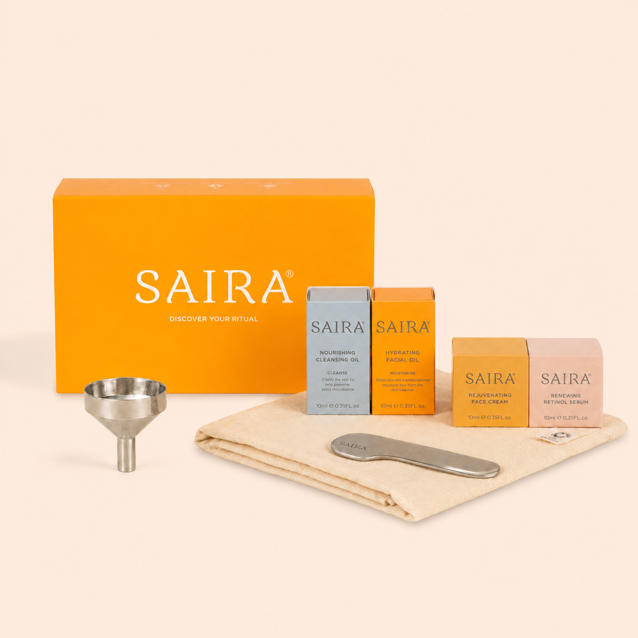 A Saira skincare set with an orange box, four smaller boxes, a cloth, a metal funnel, and an applicator.