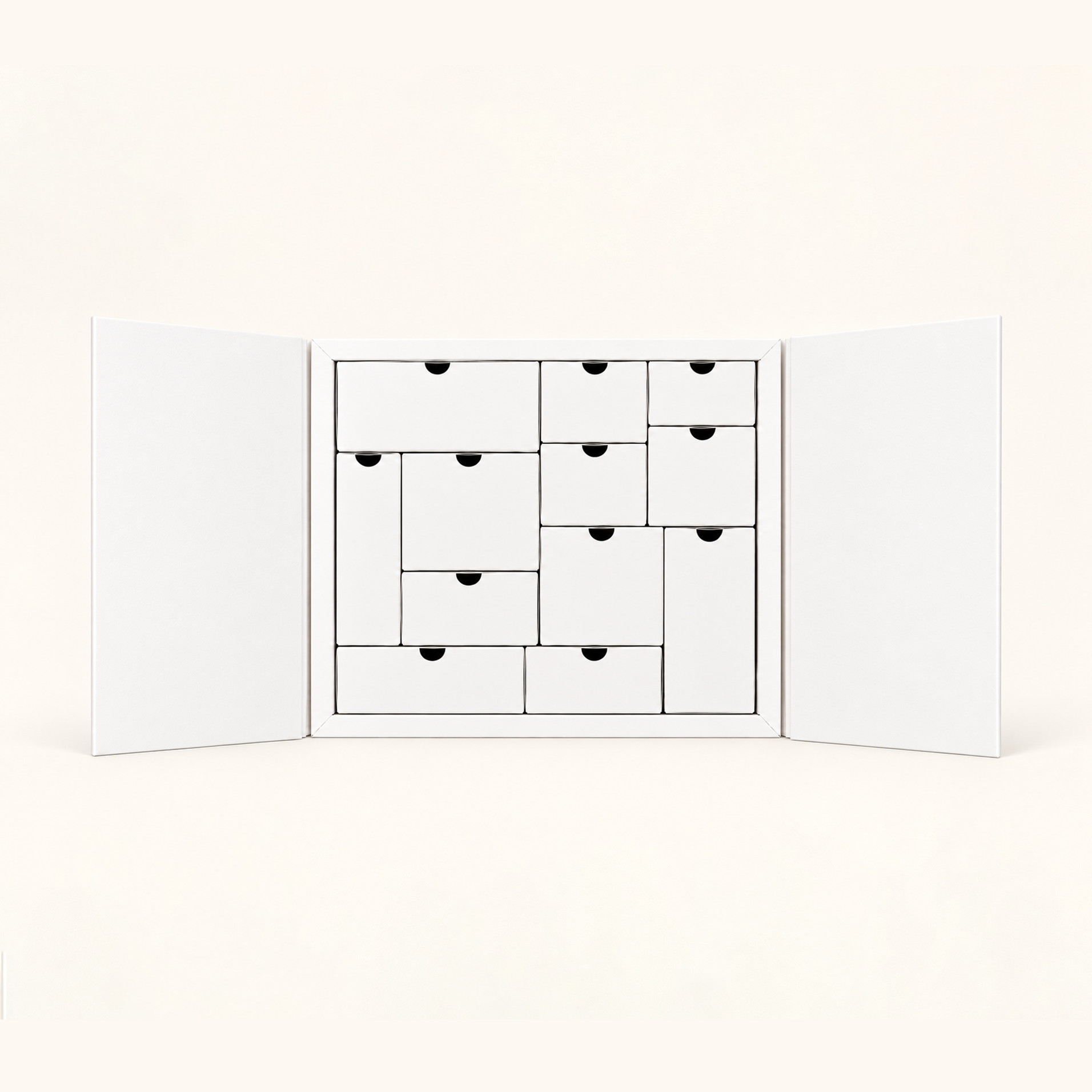 A white cabinet with open doors reveals multiple small white drawers of various sizes arranged inside.