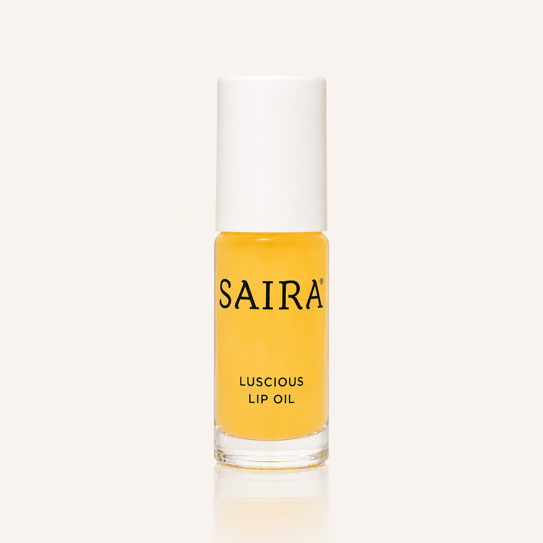 A glass bottle of Saira Luscious Lip Oil with a white cap against a plain light background.