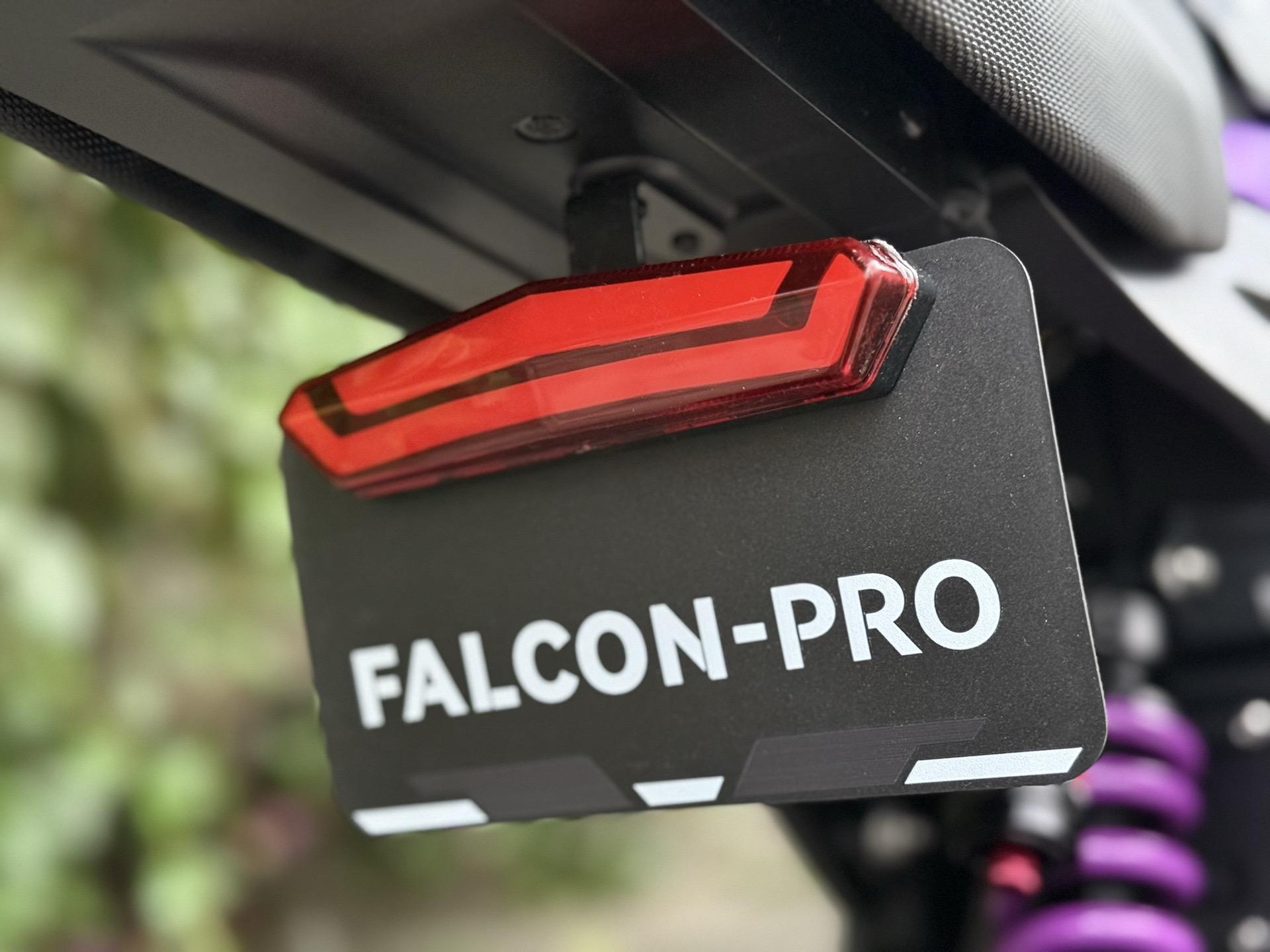 Close-up of a motorcycle's rear with 'FALCON-PRO' on the license plate.