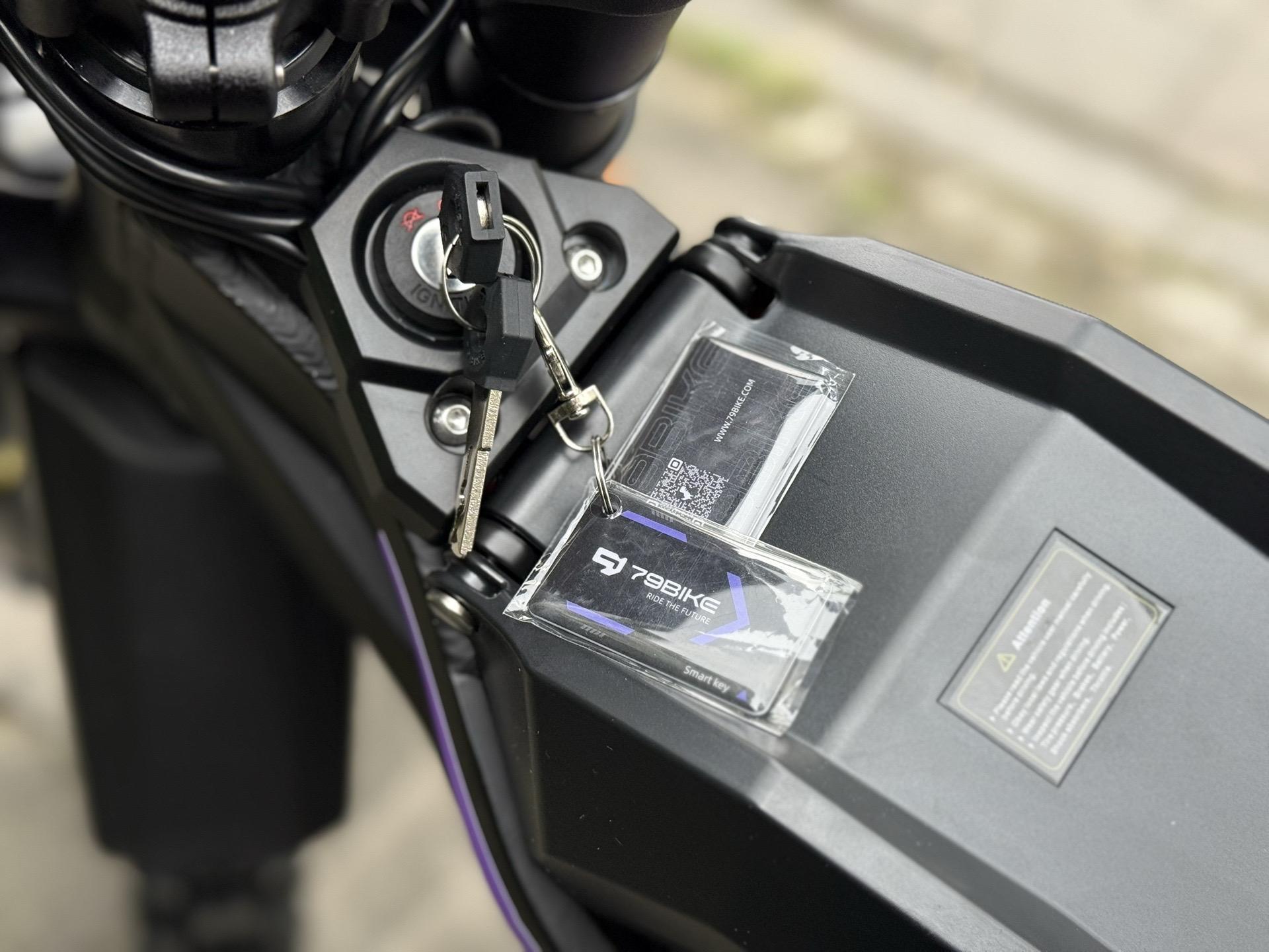 Motorcycle ignition with keys and a card holder on the tank.