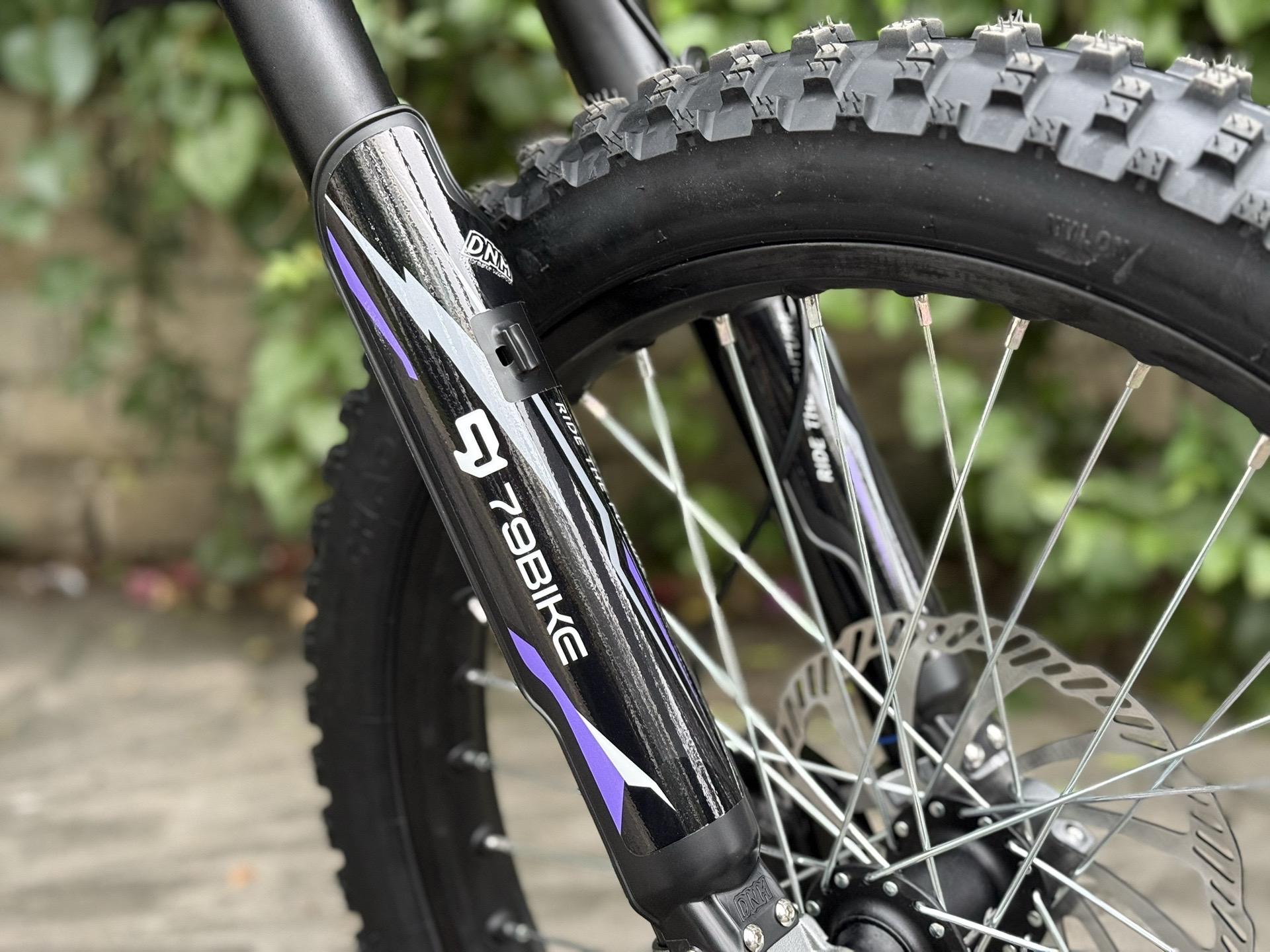 Close-up of a bicycle wheel with disc brake and tire tread.