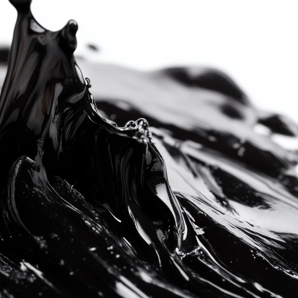 Close-up of glossy black liquid with reflective surface.