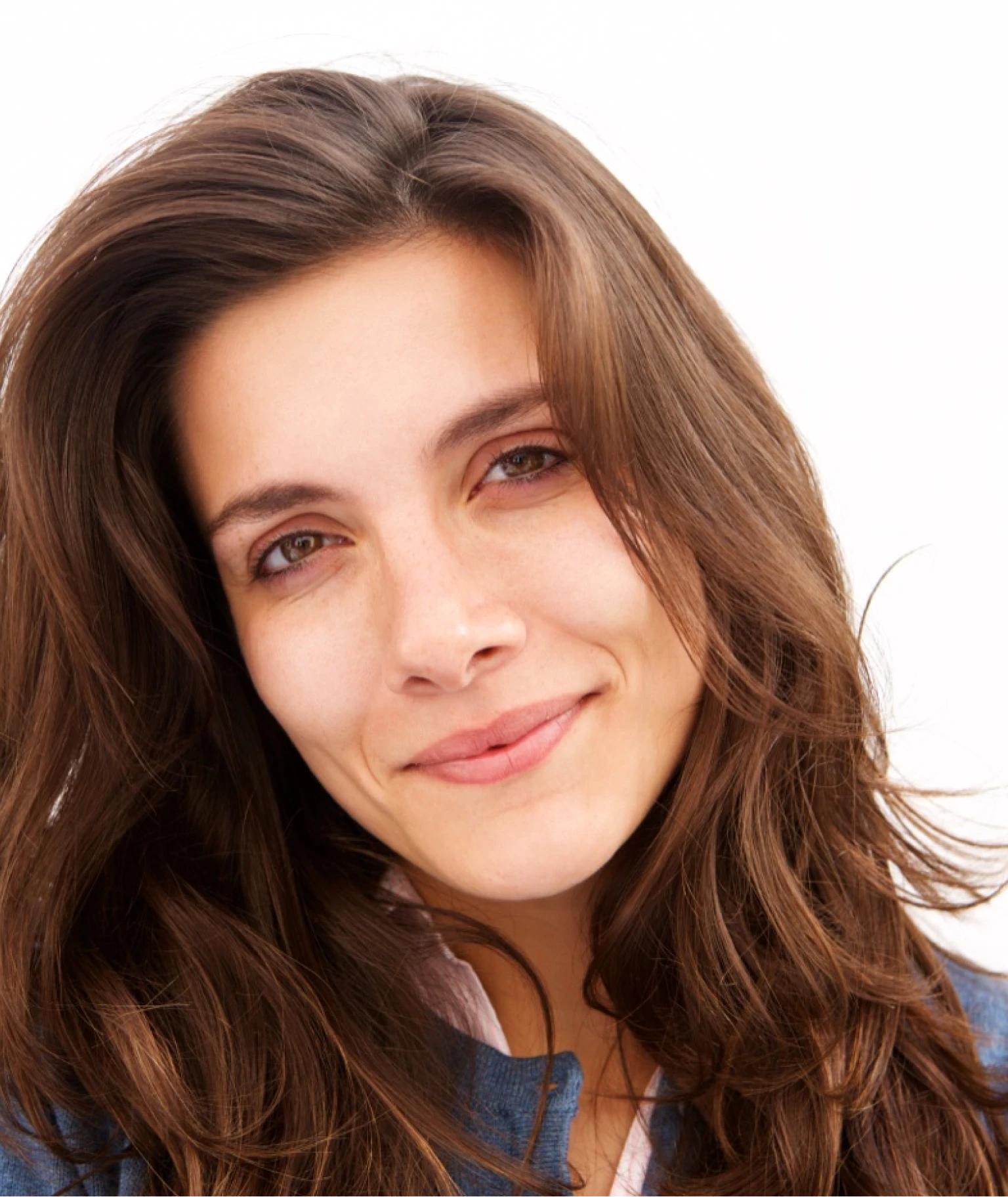 A woman with wavy, light brown hair holds a bottle of Zenagen Revolve Women's Shampoo.