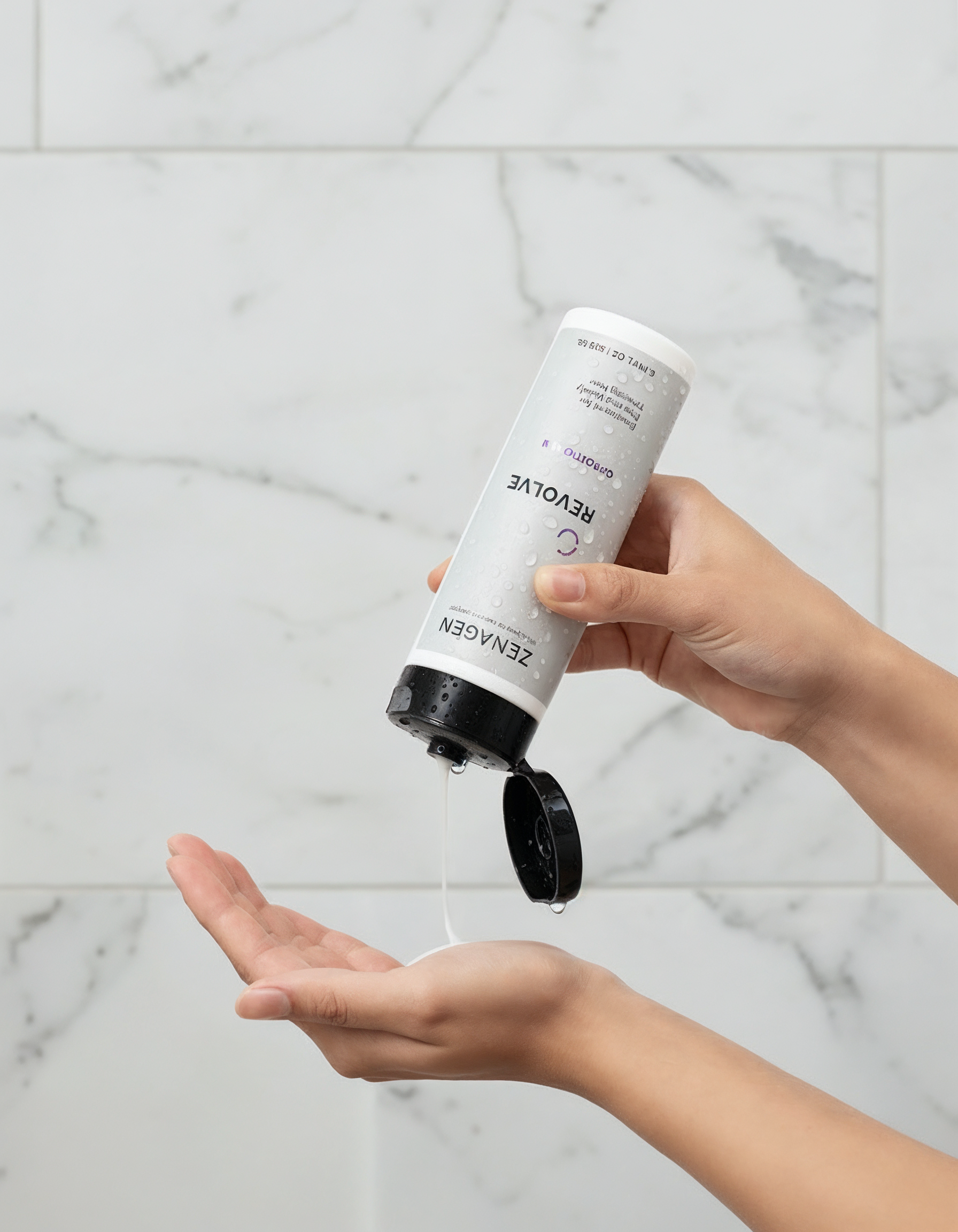 Person pouring lotion from a bottle into their palm.