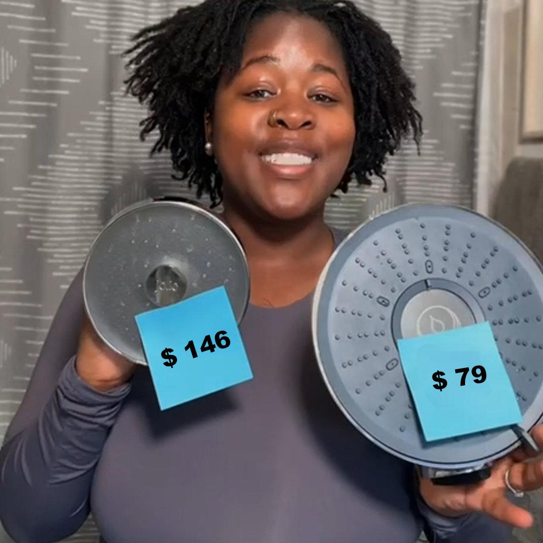 Person holding two showerheads with price tags, $146 and $79.