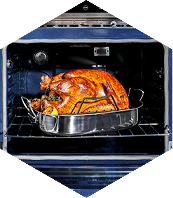 Roasted turkey in a metal pan inside an oven.
