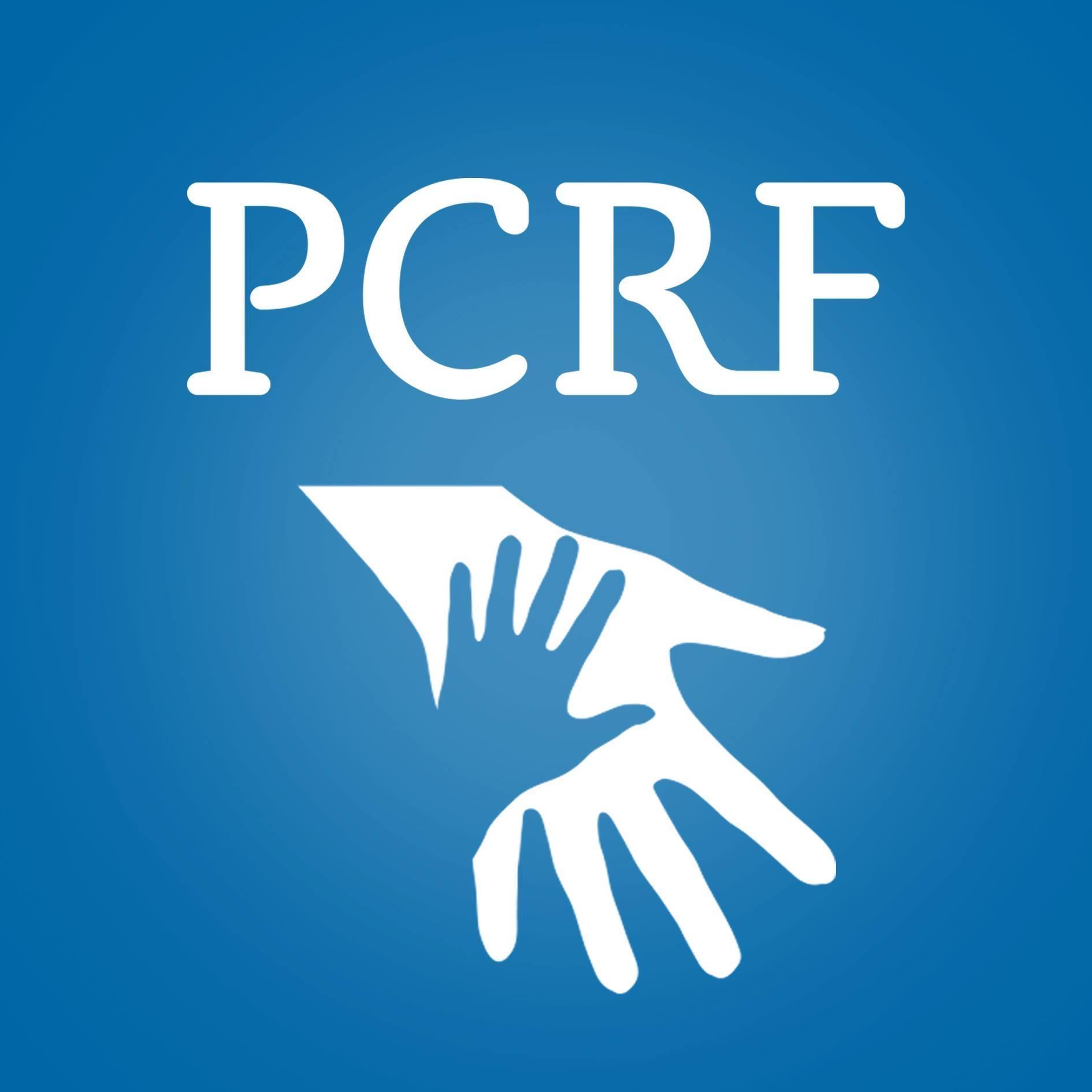 PCRF logo showing a small hand resting on a larger hand, set against a blue background.